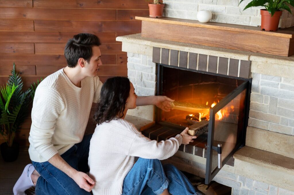 A couple sits comfortably by a fireplace, surrounded by warmth and a peaceful ambiance