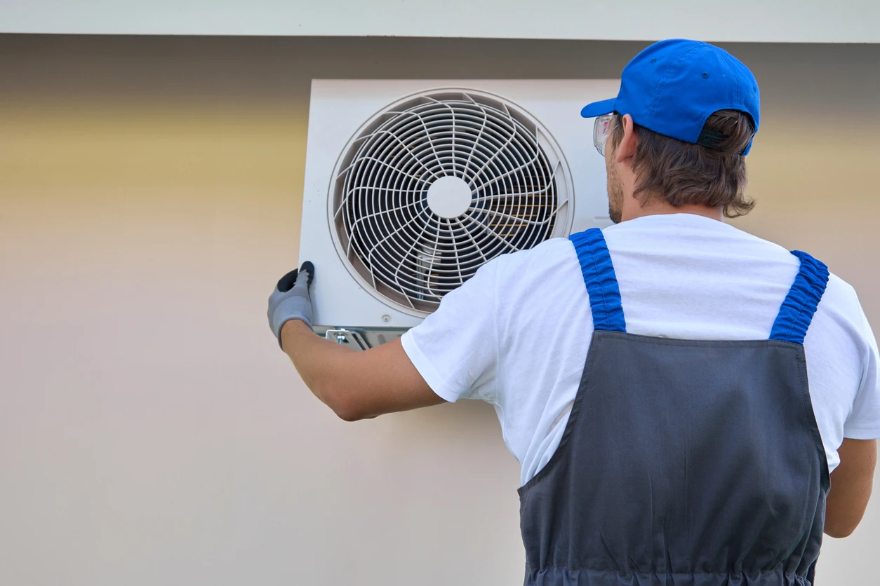 A technician is engaged in repairing an air conditioner