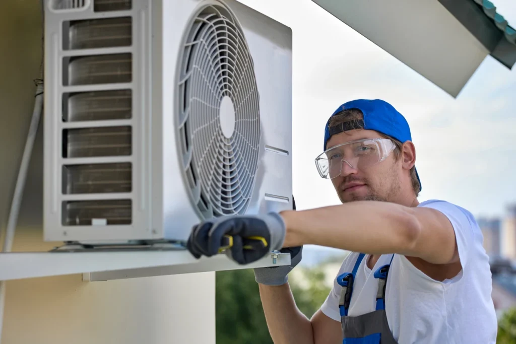 A technician is working on an air conditioning unit