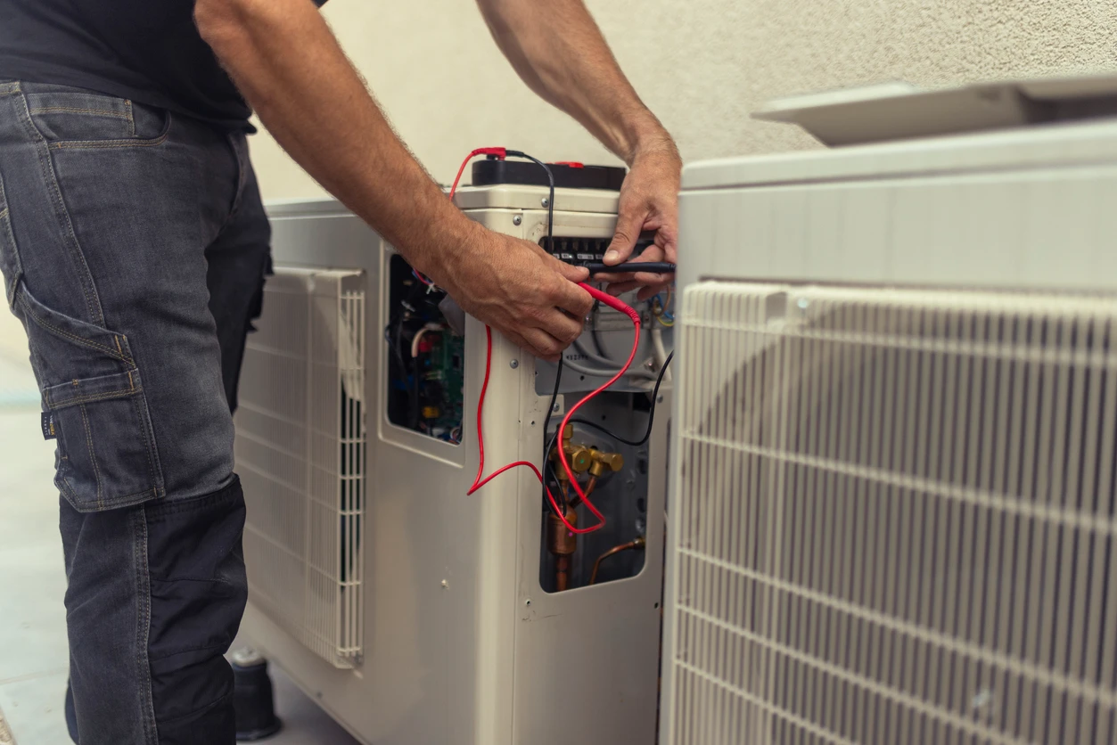 A professional is working on an air conditioner