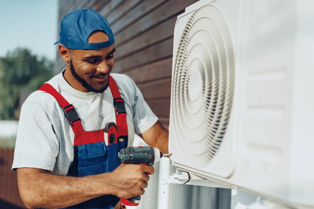 A technician is servicing an air conditioner