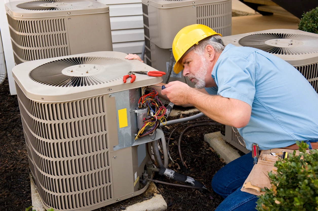 A technician is engaged in repairing an air conditioner